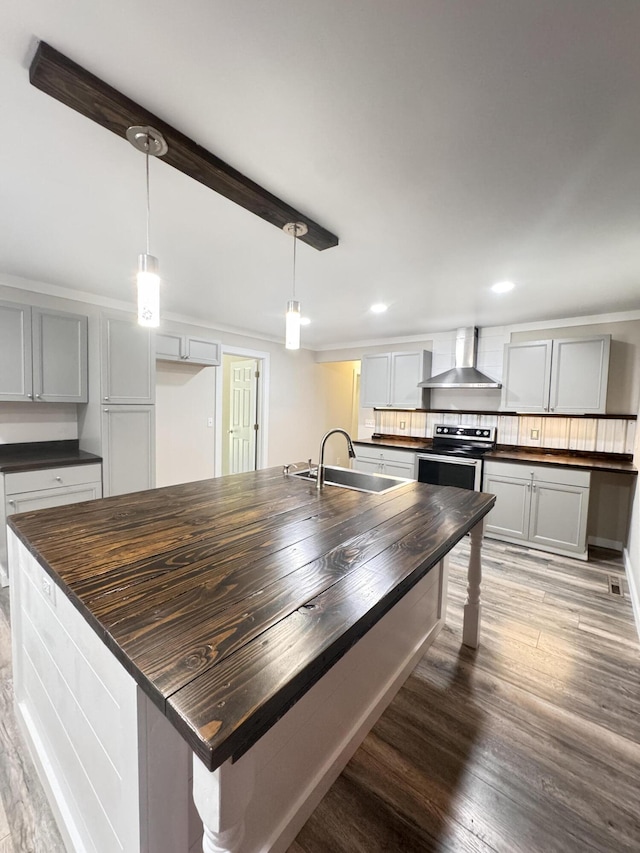 449 Estates Dr, Walterboro, SC 29488 - kitchen featuring butcher block countertops, wall chimney range hood, electric stove, wood finished floors, and recessed lighting