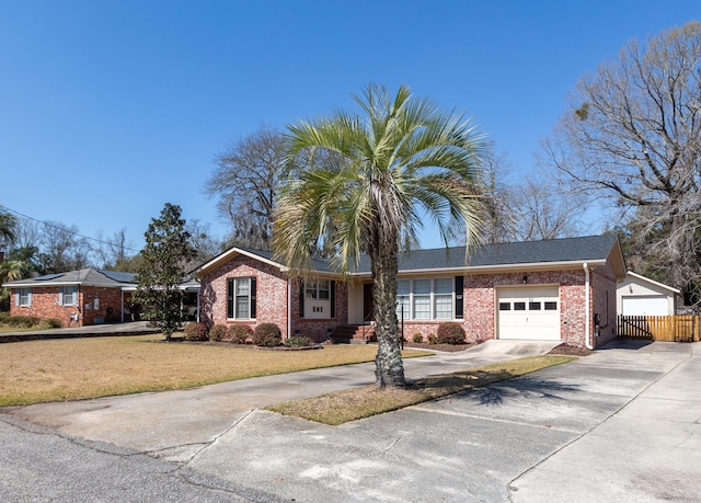 single story home with a front lawn, fence, concrete driveway, an attached garage, and brick siding