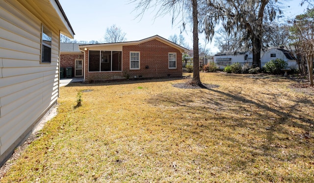 view of yard with a sunroom and fence