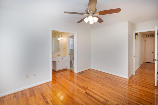 unfurnished bedroom with visible vents, baseboards, and light wood-style floors