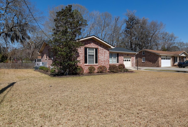 single story home with fence, an attached garage, a front lawn, concrete driveway, and brick siding