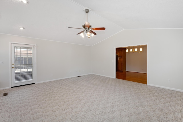 unfurnished room featuring carpet, baseboards, visible vents, ceiling fan, and vaulted ceiling