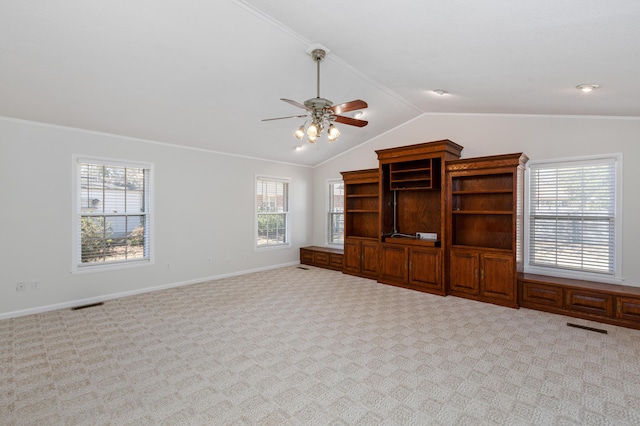 unfurnished living room with visible vents, lofted ceiling, carpet floors, crown molding, and baseboards