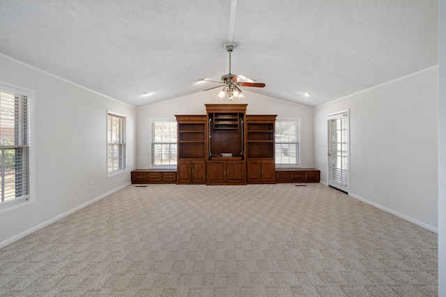 unfurnished living room featuring lofted ceiling, crown molding, carpet floors, and a textured ceiling