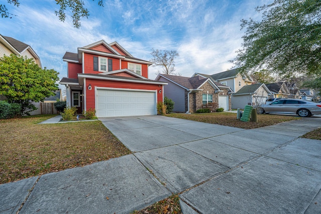 traditional home with driveway, an attached garage, a front lawn, and fence