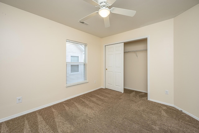 unfurnished bedroom with visible vents, baseboards, carpet flooring, a closet, and a ceiling fan