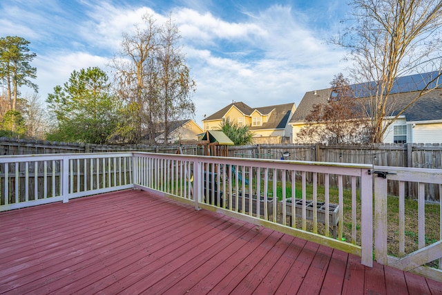 wooden terrace featuring a fenced backyard and a residential view