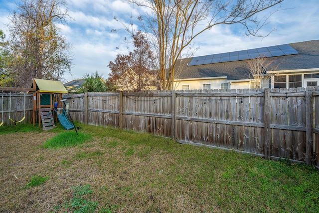 view of yard with a fenced backyard and a playground