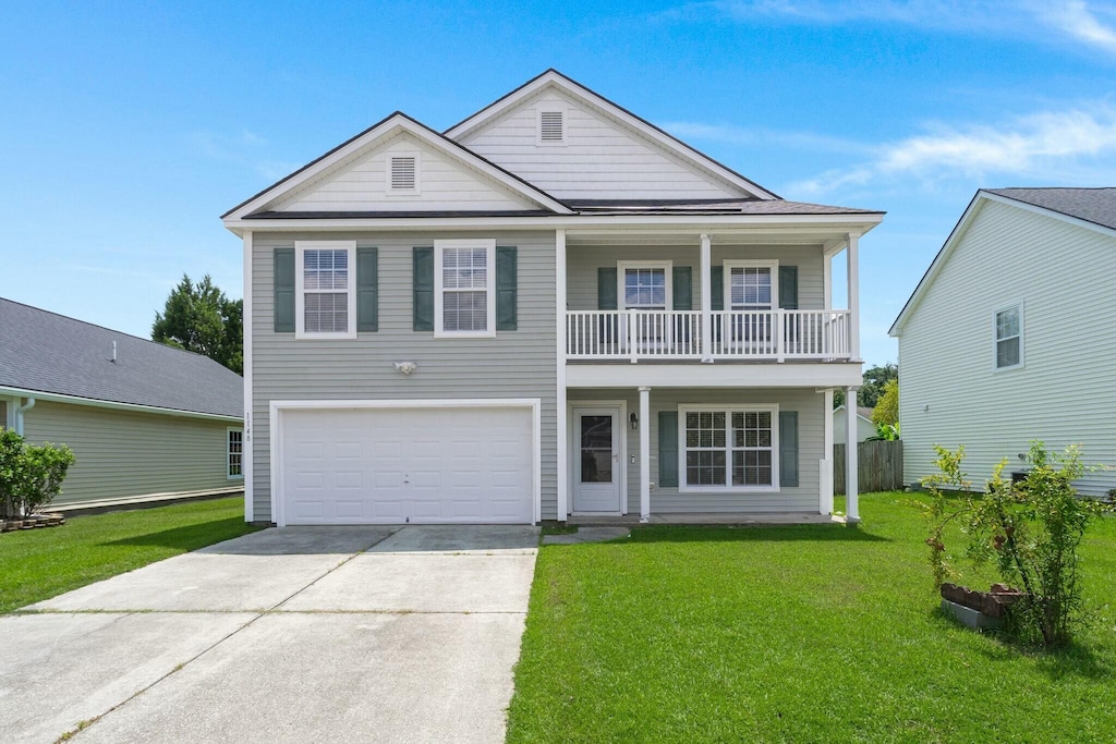 view of front of property featuring a garage and a front lawn