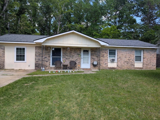 225 Arbor Rd, Summerville, SC 29485 - single story home with cooling unit, a front lawn, covered porch, and brick siding