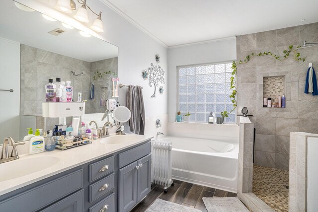 4987 Ballantine Dr, Summerville, SC 29485 - bathroom with radiator, wood finished floors, ornamental molding, a garden tub, and a walk in shower