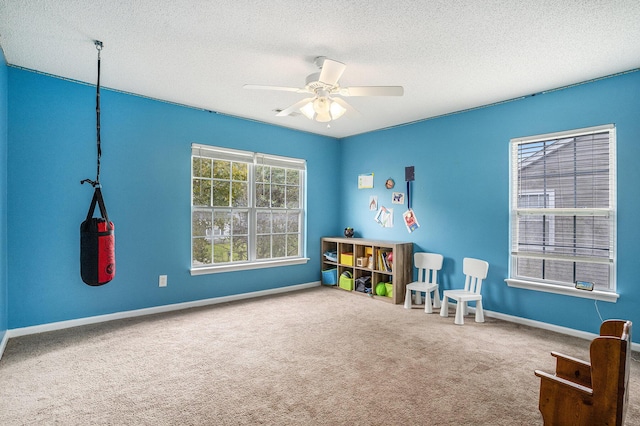 4987 Ballantine Dr, Summerville, SC 29485 - playroom with carpet flooring, a textured ceiling, a ceiling fan, and baseboards