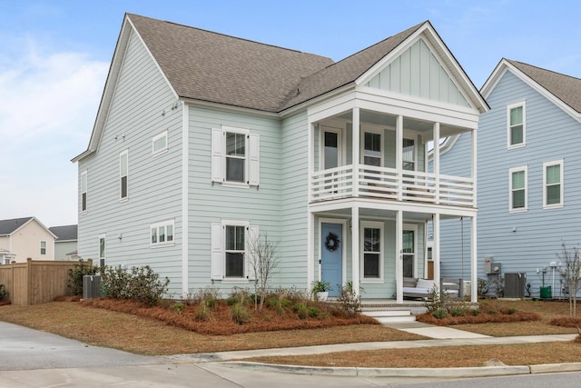 view of front of property with a porch, a balcony, and cooling unit