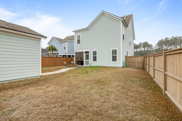 back of house featuring a patio and a lawn