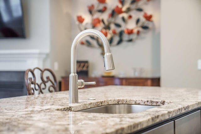 details featuring light stone counters and a sink