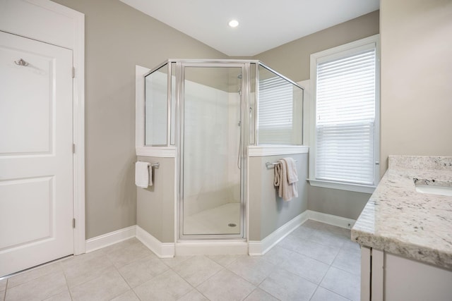 bathroom with vanity, baseboards, tile patterned floors, and a stall shower