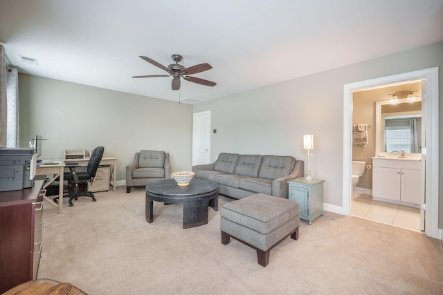 living area with a ceiling fan, baseboards, visible vents, and light carpet