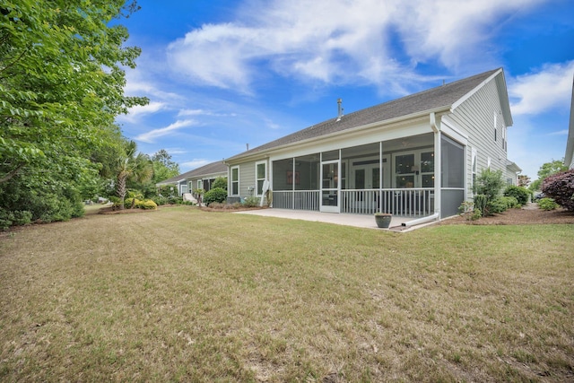 back of property featuring a yard and a sunroom