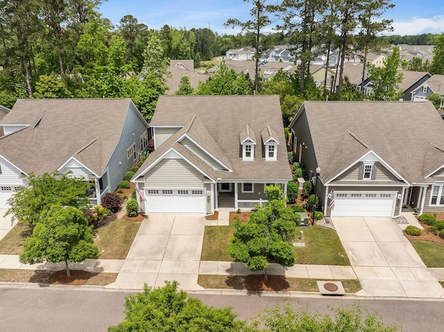 view of front of property with a residential view, covered porch, and concrete driveway