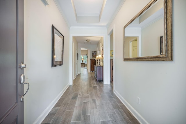 hall with baseboards and wood finished floors