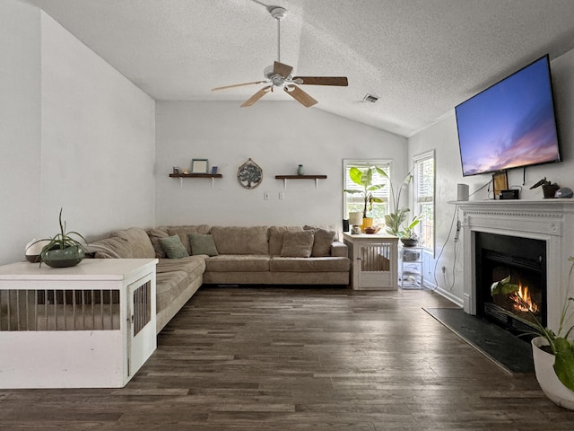1317 Wild Olive Dr, Mount Pleasant, SC 29464 - living area with vaulted ceiling, a ceiling fan, a textured ceiling, dark wood-style floors, and a glass covered fireplace
