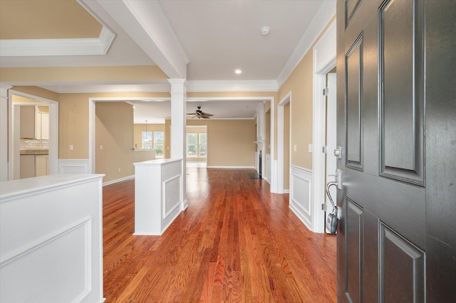 foyer featuring ceiling fan, ornamental molding, decorative columns, and hardwood / wood-style floors