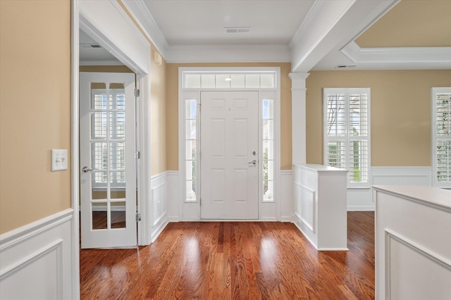 foyer featuring crown molding and dark hardwood / wood-style flooring