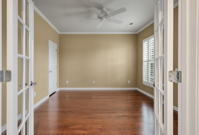 empty room with crown molding, dark hardwood / wood-style floors, and french doors