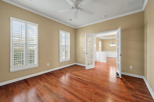 empty room with french doors, ceiling fan, ornamental molding, and hardwood / wood-style floors