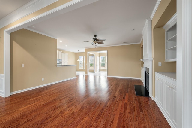 unfurnished living room with crown molding, dark hardwood / wood-style floors, and ceiling fan