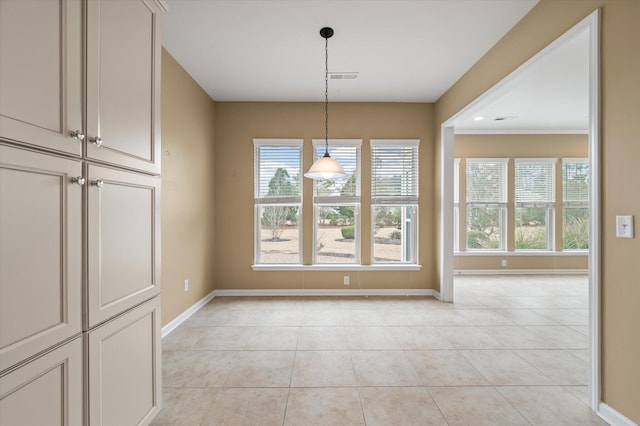 unfurnished dining area featuring light tile patterned floors