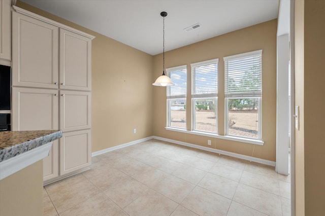 unfurnished dining area with light tile patterned floors