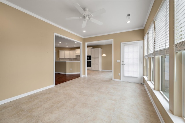 empty room with crown molding, ceiling fan, and light tile patterned flooring