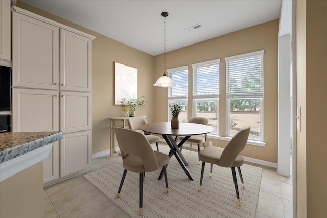 dining area featuring light tile patterned floors