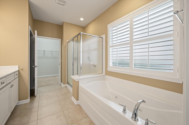 bathroom with tile patterned floors, separate shower and tub, and vanity