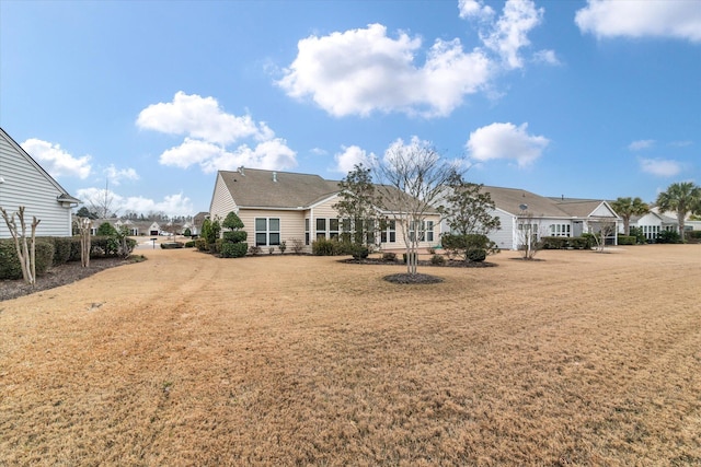 rear view of house featuring a lawn