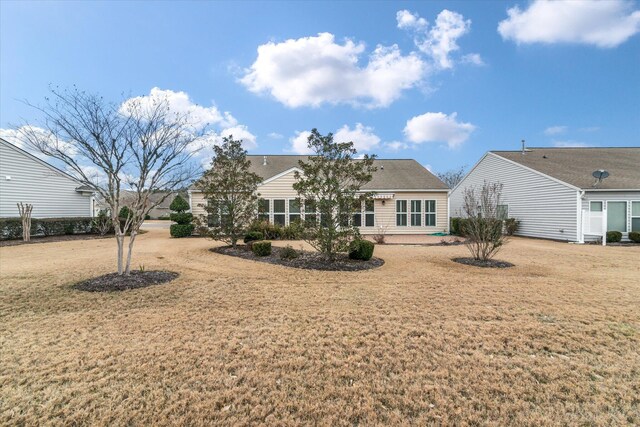 back of house featuring a lawn