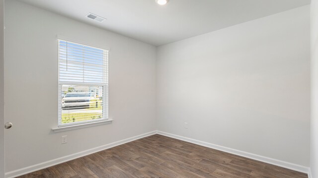 empty room featuring dark hardwood / wood-style flooring