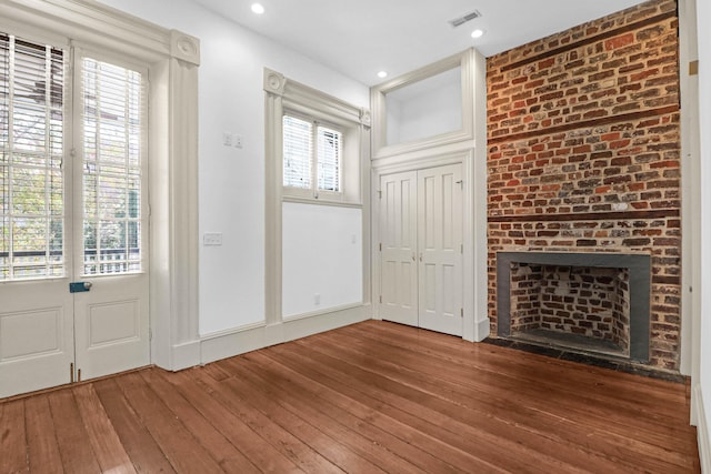 35 Society St Unit D, Charleston, SC 29401 - entryway with a brick fireplace, recessed lighting, visible vents, and hardwood / wood-style flooring