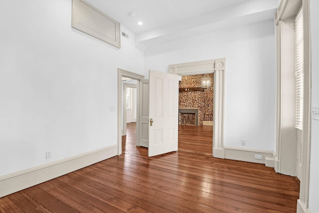 35 Society St Unit D, Charleston, SC 29401 - unfurnished bedroom featuring baseboards, a brick fireplace, visible vents, and hardwood / wood-style floors