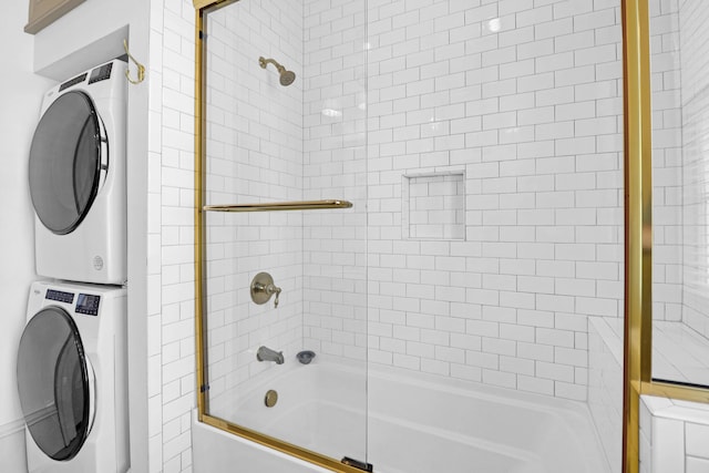 35 Society St Unit D, Charleston, SC 29401 - bathroom featuring stacked washer / drying machine and combined bath / shower with glass door