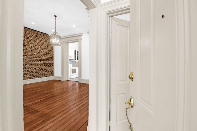 35 Society St Unit D, Charleston, SC 29401 - corridor featuring baseboards, recessed lighting, brick wall, and wood finished floors