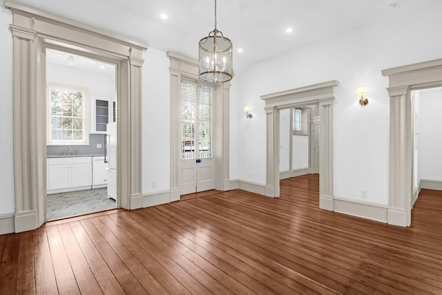 35 Society St Unit D, Charleston, SC 29401 - unfurnished dining area featuring recessed lighting, a sink, a notable chandelier, and hardwood / wood-style floors