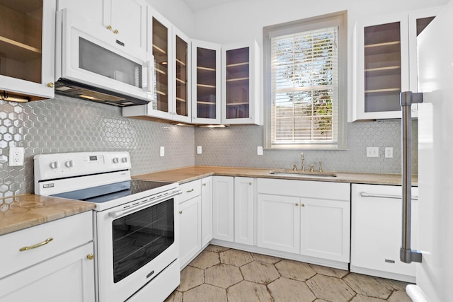 35 Society St Unit D, Charleston, SC 29401 - kitchen with backsplash, a sink, glass insert cabinets, white appliances, and white cabinetry