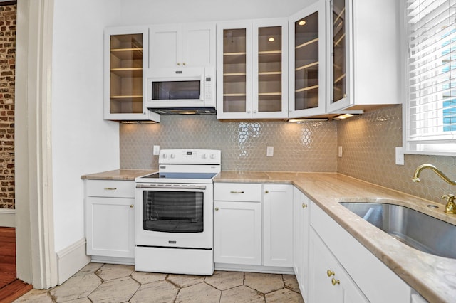 35 Society St Unit D, Charleston, SC 29401 - kitchen featuring decorative backsplash, white appliances, glass insert cabinets, white cabinets, and a sink