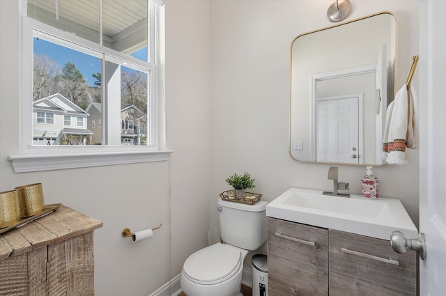 half bath featuring toilet and vanity