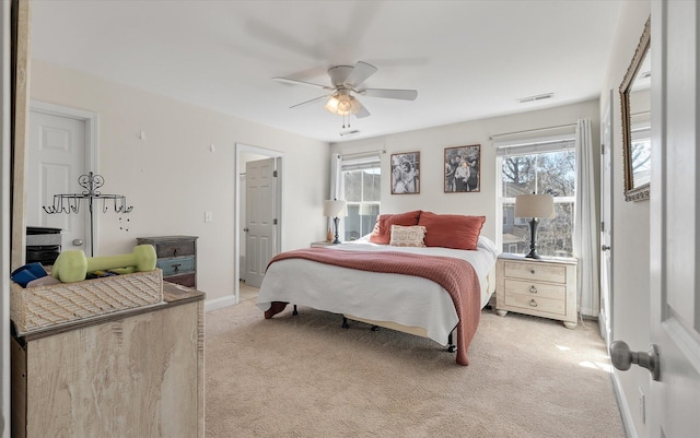 bedroom featuring visible vents, multiple windows, and light colored carpet