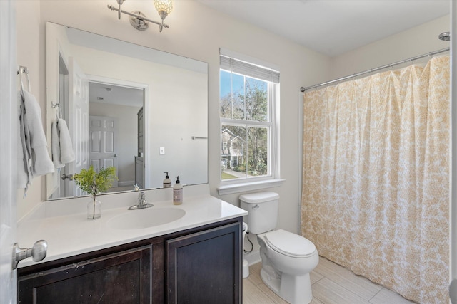 full bathroom with toilet and vanity