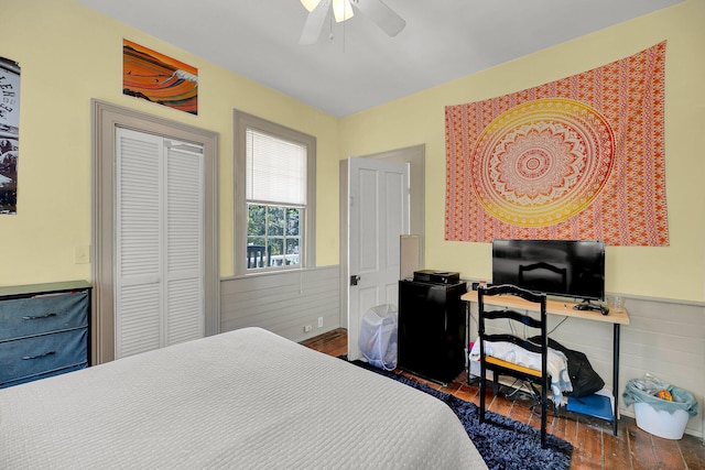 bedroom featuring a closet, dark hardwood / wood-style flooring, and ceiling fan