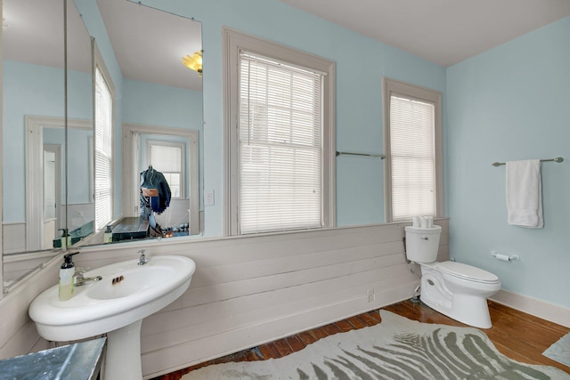 bathroom with hardwood / wood-style floors and toilet